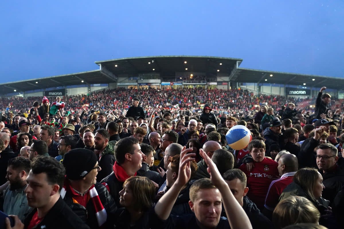 Wrexham fans celebrated promotion with a pitch invasion (Martin Rickett/PA) (PA Wire)