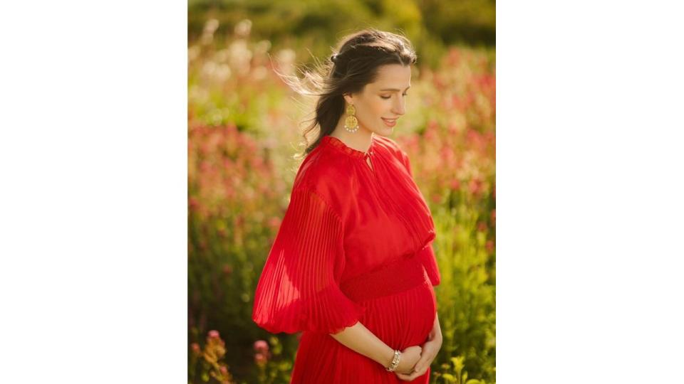 A photo of Princess Rajwa cradling her baby bump