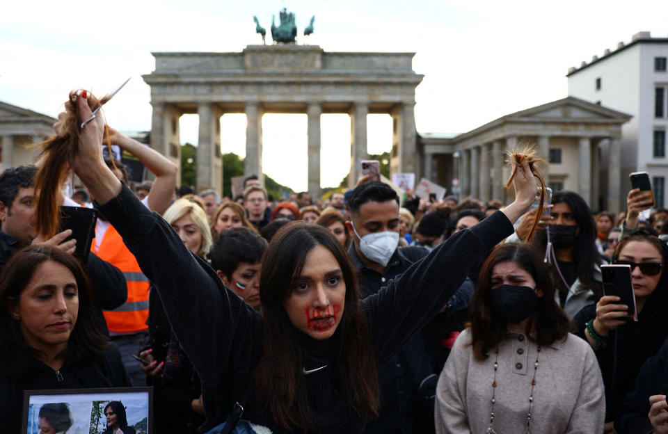 <b>Berlin, Germany</b> A demonstrator holds hair during a protest in front of the Brandenburg Gate in Berlin, Germany, Sept. 23, 2022.<span class="copyright">Christian Mang—Reuters</span>