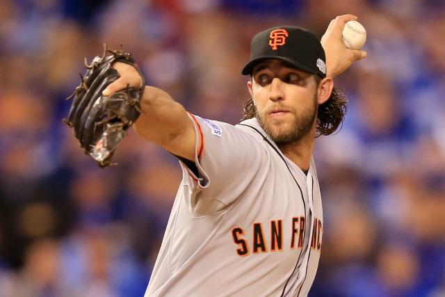 San Francisco Giants starting pitcher Madison Bumgarner touches his beard  as he walks back to the mound while working against the San Diego Padres  during the third inning of a baseball game