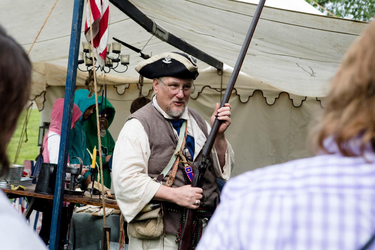 The Appalachian Festival takes place Saturday and Sunday at Coney Island. Pictured: Gary Miner, of Hillsboro, teaches people about black powder rifles during the Appalachian Festival in 2019.
