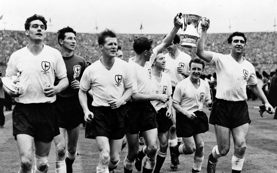 Tottenham players parade the FA Cup after completing their historic league and cup double, L-R: Ron Henry, Bill Brown, Peter Baker, Danny Blanchflower, Cliff Jones, Maurice Norman, Terry Dyson, and Bobby Smith - Popperfoto via Getty Images/Getty Images