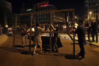 Anti-government protesters block a road during a protest against the political leadership they blame for the economic and financial crisis, in Beirut, Lebanon, Thursday, June 11, 2020. (AP Photo / Hussein Malla)