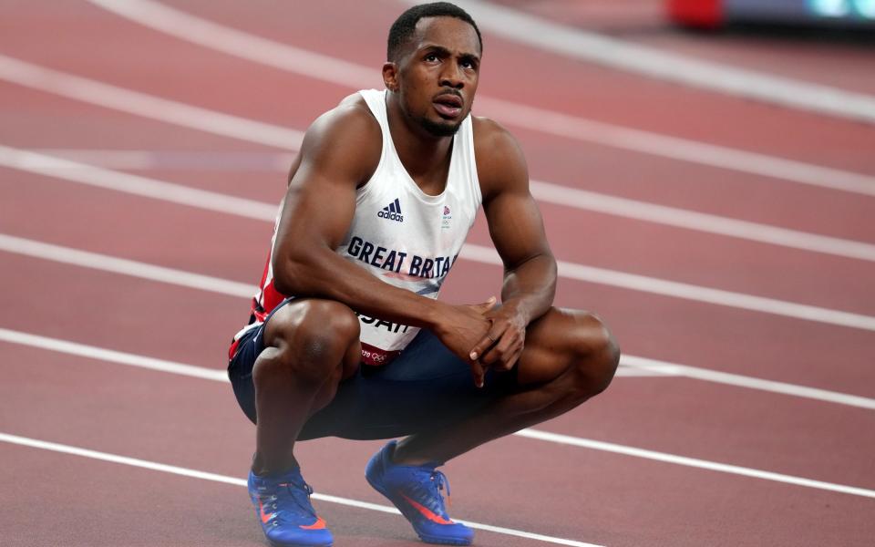 CJ Ujah crouching on the track, looking upwards