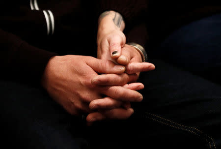 Family members of Westminster Bridge attack victims Melissa and Kurt Cochran hold hands during a news conference at New Scotland Yard, in London, Britain, March 27, 2017. REUTERS/Stefan Wermuth