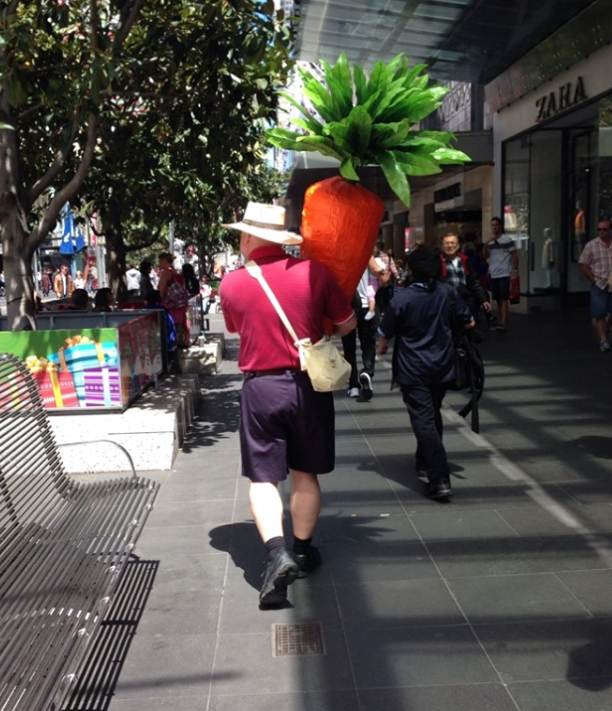 "Carrot man" Nathan walking in Melbourne with his giant vegetable. 