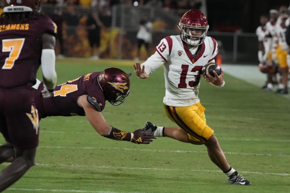 USC quarterback Caleb Williams carries the ball against Arizona State in the first half.