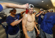 Los Angeles Dodgers' Tim Locastro is bathed in beer and champagne as he celebrates with teammates after clinching a playoff spot after beating the San Francisco Giants in a baseball game in San Francisco, Saturday, Sept. 29, 2018. (AP Photo/Jim Gensheimer)