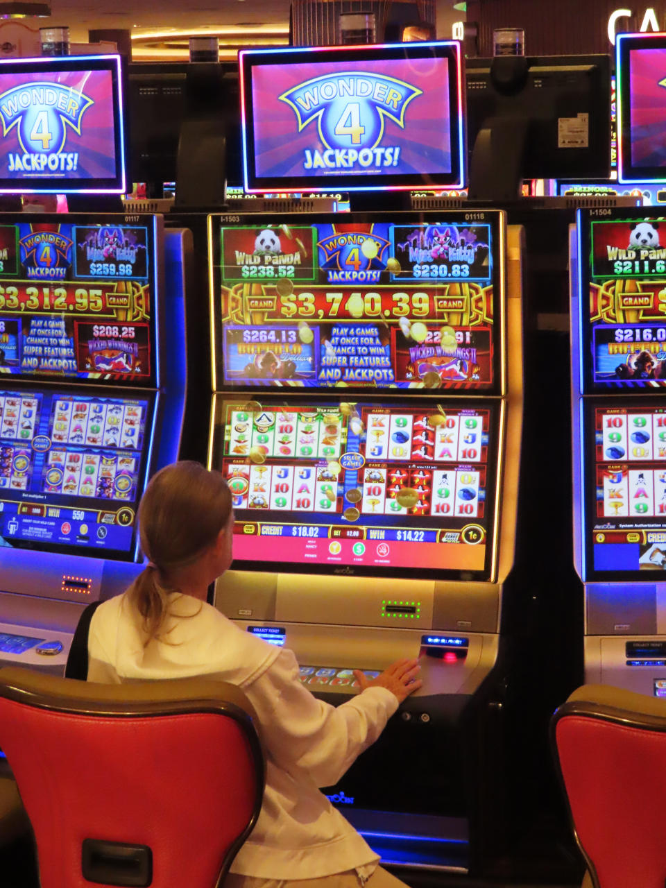 A gambler plays a slot machine at the Hard Rock casino in Atlantic City, N.J., Aug. 8, 2022. On Oct. 17, 2022, New Jersey gambling regulators reported Atlantic City's casinos won nearly $252 million from in-person gamblers in September, putting them on track to exceed pre-pandemic levels of revenue by the end of the year. (AP Photo/Wayne Parry)