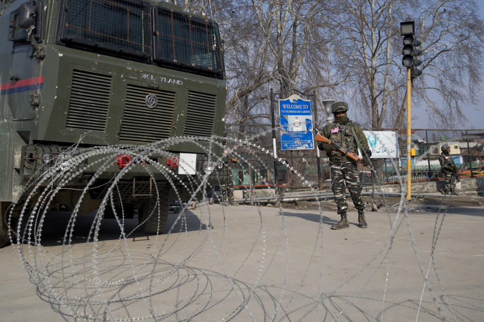 Indian paramilitary soldiers are seen near a barbed wire at a checkpoint during a strike in Srinagar, Indian controlled Kashmir, Sunday, Feb. 3, 2019. India's prime minster is in disputed Kashmir for a daylong visit Sunday to review development work as separatists fighting Indian rule called for a shutdown in the Himalayan region. (AP Photo/Dar Yasin)