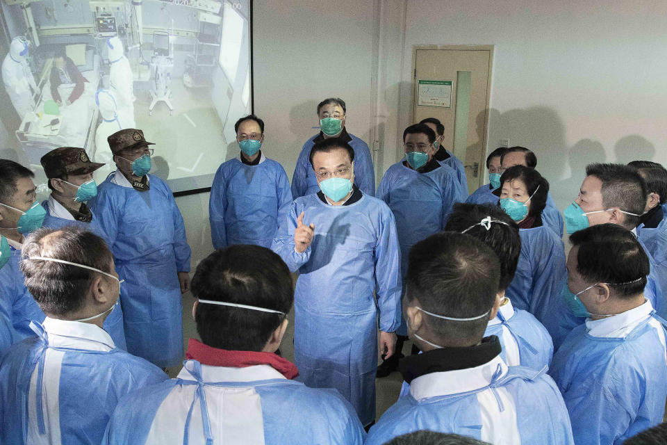 FILE - In this photo released by China's Xinhua News Agency, Chinese Premier Li Keqiang, center, wears a mask as he speaks with medical workers during the start of the COVID pandemic at Wuhan Jinyintan Hospital in Wuhan in central China's Hubei province, Jan. 27, 2020. For most of his career, Li was known as a cautious, capable, and highly intelligent bureaucrat who rose through, and was bound by, a consensus-oriented Communist Party that reflexively stifles dissent. (Li Tao/Xinhua via AP, File)