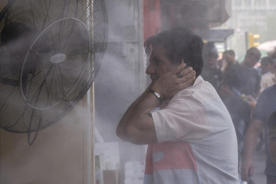 FILE - A man cools off during a heat wave in Baghdad, Iraq, July, 6, 2023. Earth last year shattered global annual heat records, the European climate agency said Tuesday, Jan. 9, 2024. (AP Photo/Hadi Mizban, File)