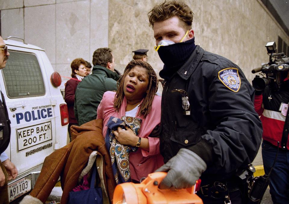 In this file photo of Feb. 26, 1993, a New York City police officer leads a woman to safety following the underground bomb blast of a rented van loaded with fertilizer at the World Trade Center. The first attack on the towers killed six people and injured more than 1,000.   There have been at least nine planned terror attacks in the city since the Sept. 11, 2001 attacks, but more often than not, terrorist plots have failed. On Saturday, May 1, 2010, a smoking SUV in Times Square was discovered before the explosives inside could do any damage, but for New Yorkers, the question always remains: What about next time?