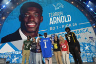 Alabama cornerback Terrion Arnold, center, poses after being chosen by the Detroit Lions with the 24th overall pick during the first round of the NFL football draft, Thursday, April 25, 2024, in Detroit. (AP Photo/Paul Sancya)