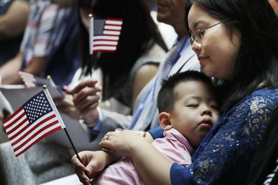 Meimei Li from China holds her son Ryan, 3, during her naturalization ceremony on July 3, 2018, at the New York Public Library. (Photo: Mark Lennihan/AP)