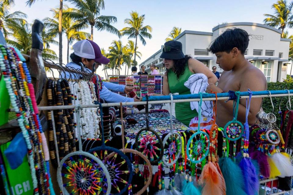 Vida, 37, and her son Ayden, 12, purchase jewelery from Ana De La Torre during Memorial Day weekend at Miami Beach, Florida, on Sunday, May 28, 2023.