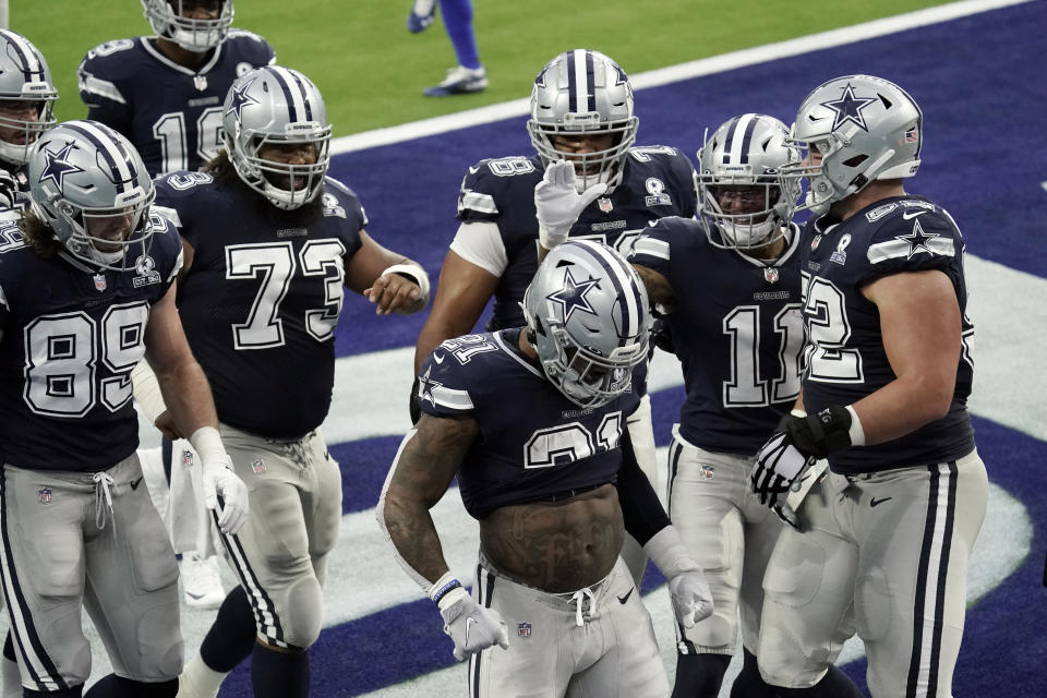 Dallas Cowboys running back Ezekiel Elliott (21) celebrates after scoring a touchdown against the Los Angeles Rams during the first half of an NFL football game Sunday, Sept. 13, 2020, in Inglewood, Calif. (AP Photo/Jae C. Hong )