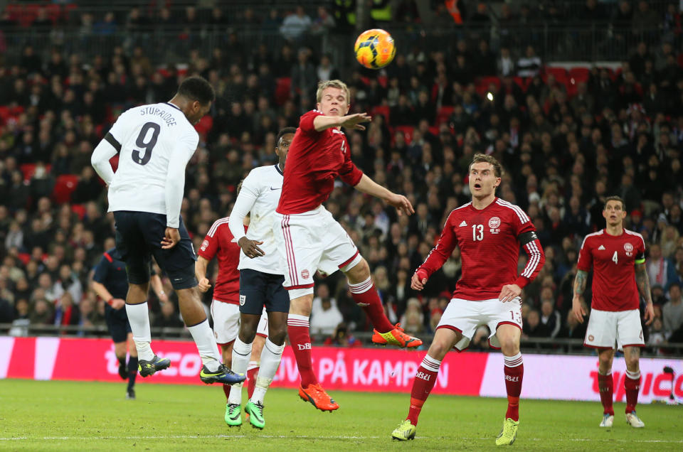 England's Daniel Sturridge, left heads the ball to score the opening goal of the game during the international friendly soccer match between England and Denmark at Wembley stadium in London Wednesday, March 5, 2014. (AP Photo/Alastair Grant)