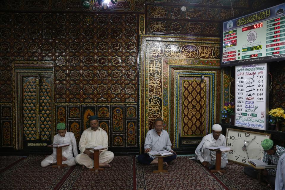 <p>Kashmiri Muslims read verses from the Quran, Islam’s holy book, inside the shrine of Shah-e-Hamdan during Ramadan in Srinagar, Kashmir, May 29, 2017. (AP Photo/Mukhtar Khan) </p>