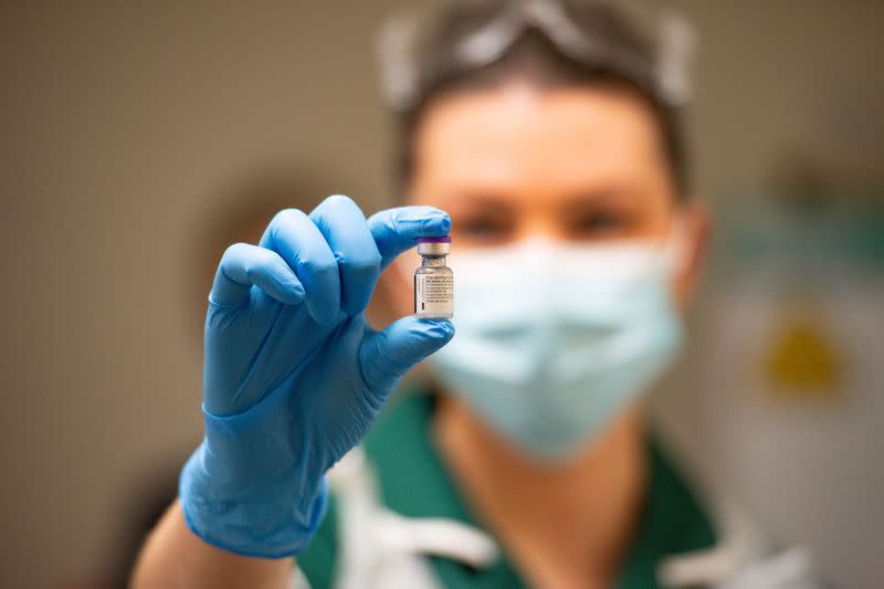 A nurse holds a phial of the Pfizer/BioNTech COVID-19 vaccine at University Hospital in Coventry