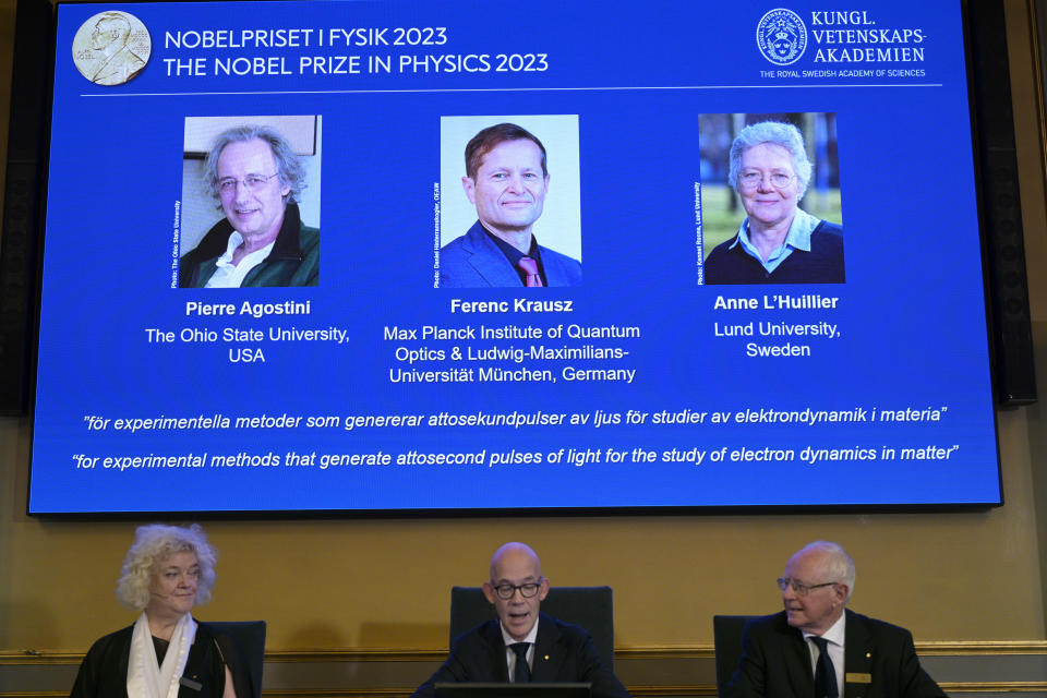 Permanent Secretary of the Royal Academy of Sciences, Hans Ellegren, center, together with members Eva Olsson, right, and Mats Larsson, announces the winner of the 2023 Nobel Prize in Physics, at the Royal Academy of Sciences, in Stockholm, Tuesday, Oct. 3, 2023. The Nobel Prize in physics has been awarded to Pierre Agostini, Ferenc Krausz and Anne L’Huillier for looking at electrons in atoms by the tiniest of split seconds. (Anders Wiklund/TT News Agency via AP)