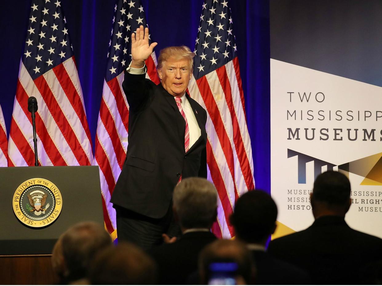 President Donald Trump waves after speaking following a tour of the Mississippi Civil Rights Museum on 9 December 2017 in Jackson, Mississippi: Joe Raedle/Getty Images