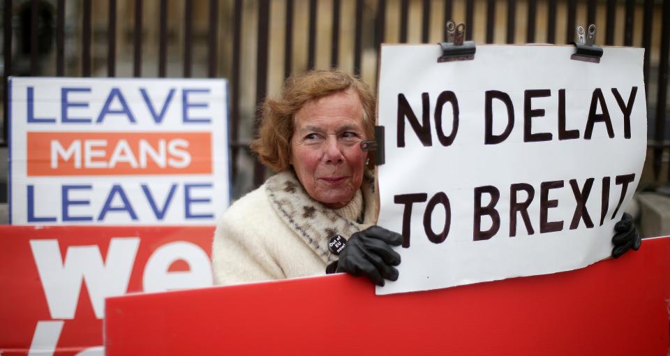 Pro-Brexit activists hold placards as they demonstrate outside the Houses of Parliament in central London. Photo: Daniel Leal-Olivas/AFP/Getty Images