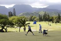 U.S. President Barack Obama (2nd L) steps over the putting line of friend Bobby Titcomb (L) while playing on the 18th green during a round of golf at Mid Pacific Country Club in Kailua, Hawaii December 23, 2013. REUTERS/Kevin Lamarque (UNITED STATES - Tags: POLITICS SPORT GOLF)