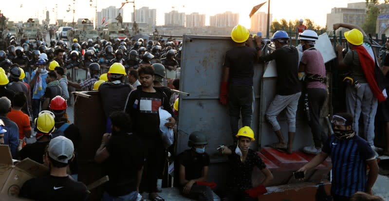 Demonstrators block Al Shuhada bridge during ongoing anti-government protests, in Baghdad