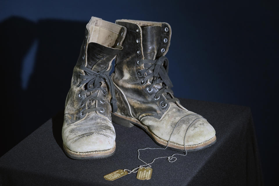 Combat boots and dog tags worn by Alan Alda as he portrayed the wisecracking surgeon Hawkeye on the beloved television series "M-A-S-H" are displayed at Heritage Auctions in Irving, Texas, Wednesday, July 5, 2023. The items are up auction on July 28. (AP Photo/LM Otero)