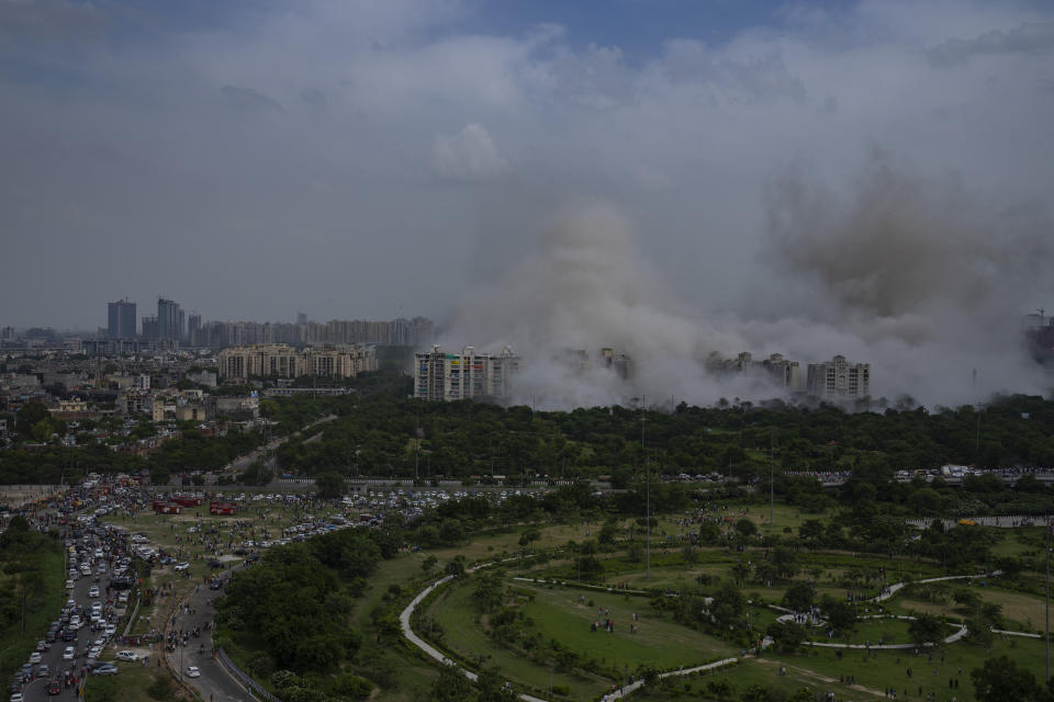 Cloud of dust rises as twin high-rise apartment towers are razed to ground in Noida, outskirts of New Delhi, India, Sunday, Aug. 28, 2022. The demolition was done after the country's top court declared them illegal for violating building norms. The 32-story and 29-story towers, constructed by a private builder were yet to be occupied and became India's tallest structures to be razed to the ground. (AP Photo/Altaf Qadri)