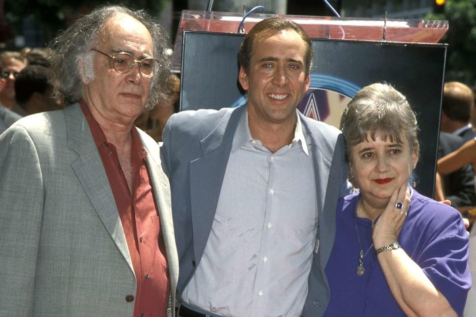 <p>Ron Galella, Ltd./Ron Galella Collection via Getty</p> Nicolas Cage (center) and his father August Coppola and mother Joy Vogelsang attend his Hollywood Walk of Fame ceremony in 1998.
