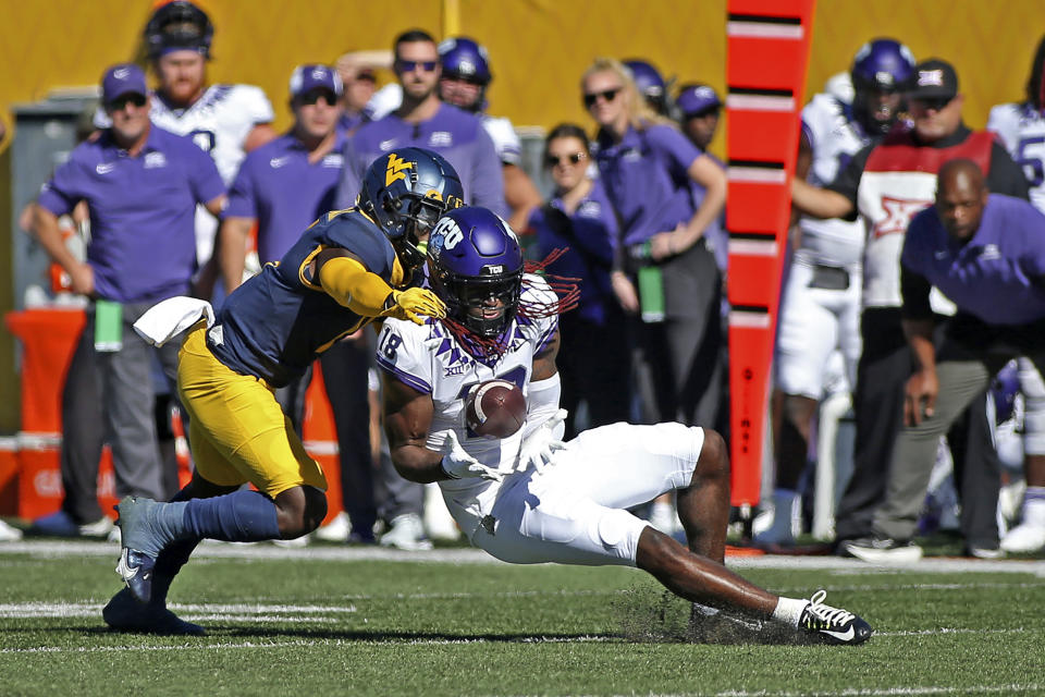 TCU wide receiver Savion Williams (18) catches a pass as West Virginia cornerback Wesley McCormick (11) defends during the first half of an NCAA college football game in Morgantown, W.Va., Saturday, Oct. 29, 2022. (AP Photo/Kathleen Batten)
