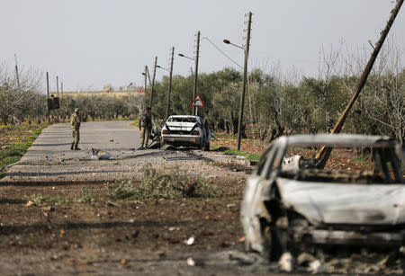 Debris and wreckage of cars seen along a road after Turkish-backed Free Syrian Army fighters advanced north of Afrin, March 8. REUTERS/Khalil Ashawi