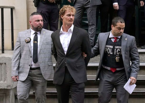 PHOTO: Daniel Penny, center, is walked out of the New York Police Department 5th Precinct in Lower Manhattan, May 12, 2023. (Timothy A. Clary/AFP via Getty Images)