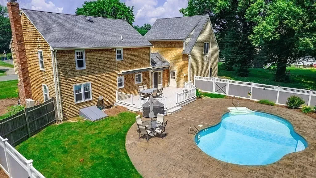 This house at 10 Eliab Latham Way in East Bridgewater that sold for $742,000 on Aug. 22, 2023, has a backyard oasis with built-in pool, gardens, flag pole and a large deck with awnings. This property was sold by Joyce Augustson at Jack Conway.