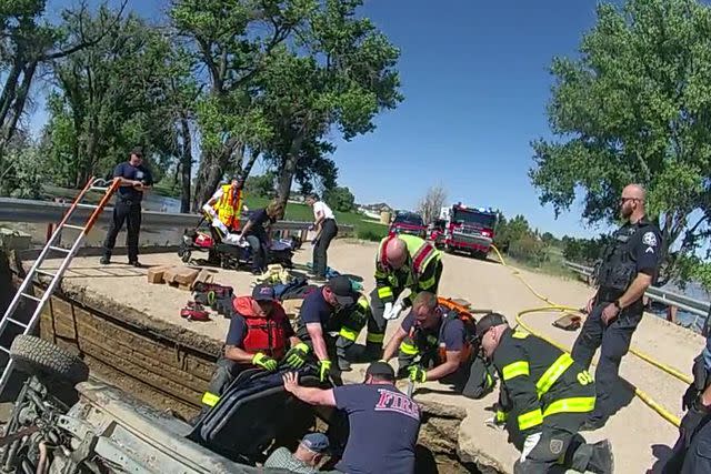 <p>Courtesy Colorado State Patrol</p> Firefighters rescuing passengers from a sinkhole bridge on Weld County Road 2 on June 24, 2023.