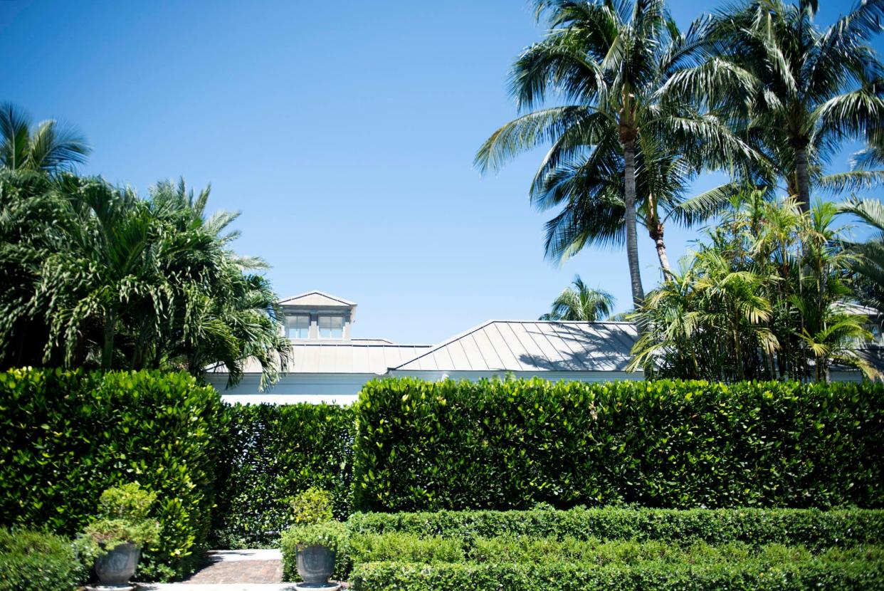 Tall hedges hide much of the house at 309 Garden Road in Palm Beach from the view of passersday. The house is seen in a photo taken September 5, 2023.