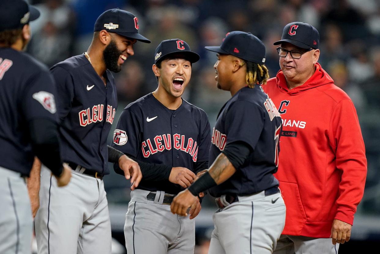 Guardians shortstop Amed Rosario, left, left fielder Steven Kwan, center, third baseman Jose Ramirez and manager Terry Francona joke around on the field playing against the Yankees in Game 1 of an American League Division Series, Tuesday, Oct. 11, 2022, in New York.