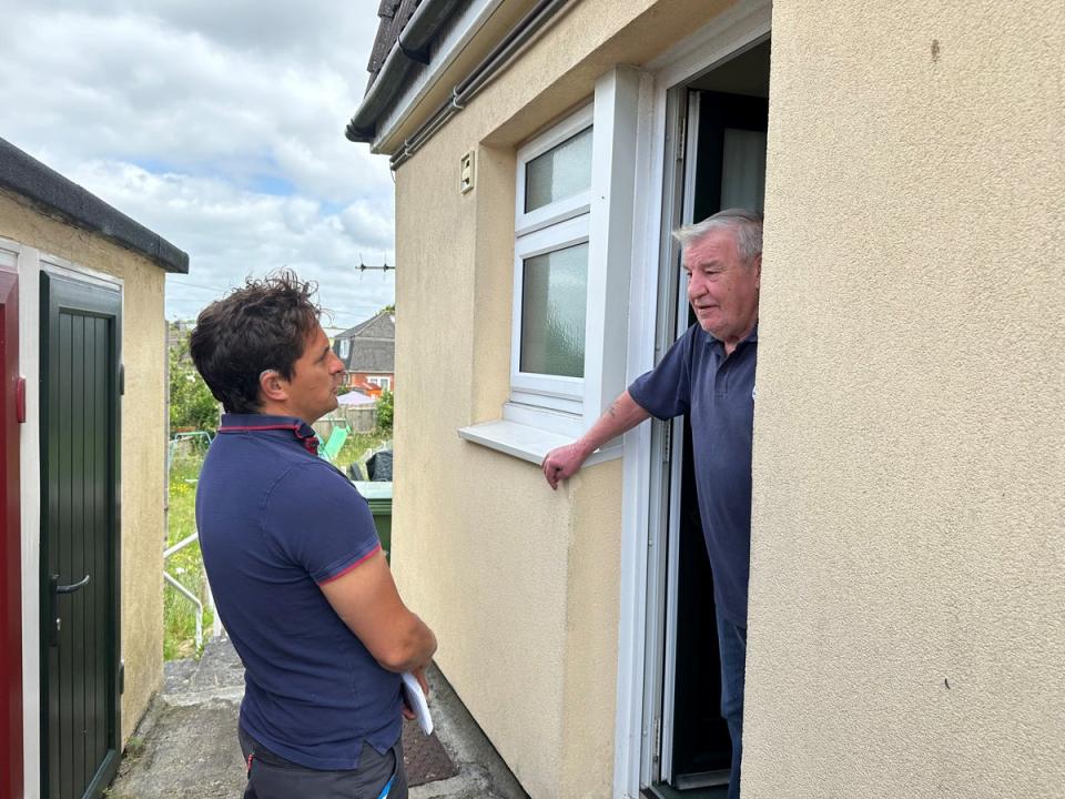 Johnny Mercer speaking to a Conservative voter in Ernesettle in Plymouth during canvassing on Thursday (The Independent)
