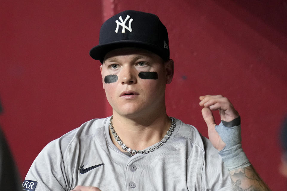 New York Yankees' Alex Verdugo pauses in the dugout during the seventh inning of a baseball game against the Arizona Diamondbacks Tuesday, April 2, 2024, in Phoenix. During his time with the Boston Red Sox, Alex Verdugo frequently played with several gaudy chains bouncing around his neck. He packs at least six for every road trip, and he's lost count of how many he owns. In his first season with the famously clean-cut New York Yankees, Verdugo has been given an order by manager Aaron Boone: only one chain per game.(AP Photo/Ross D. Franklin)