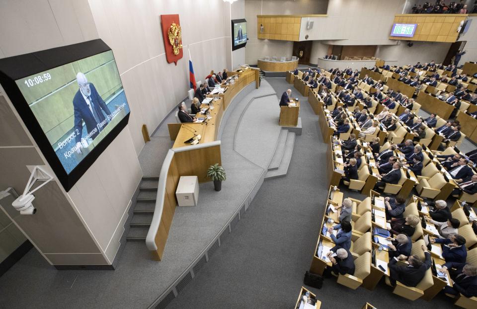 Pavel Krasheninnikov, lawmaker and co-chair of the constitutional reform working group, background center, speaks during a session at the Russian State Duma, the Lower House of the Russian Parliamentin Moscow, Russia, Thursday, Jan. 23, 2020. The Russian lower house of parliament, the State Duma, holds the first of three readings and a vote on a draft bill on constitutional proposals put forward by the Kremlin. The package of constitutional amendments is widely seen as an attempt to secure President Vladimir Putin's grip on power well after his current term ends in 2024. (AP Photo/Alexander Zemlianichenko)