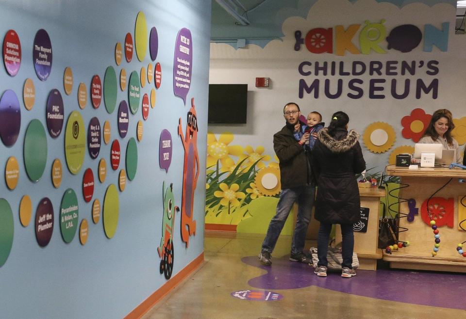A family checks in at the Akron Children's Museum on Jan. 19, 2020 in Akron. Daily programs available on the museum's website. More information at