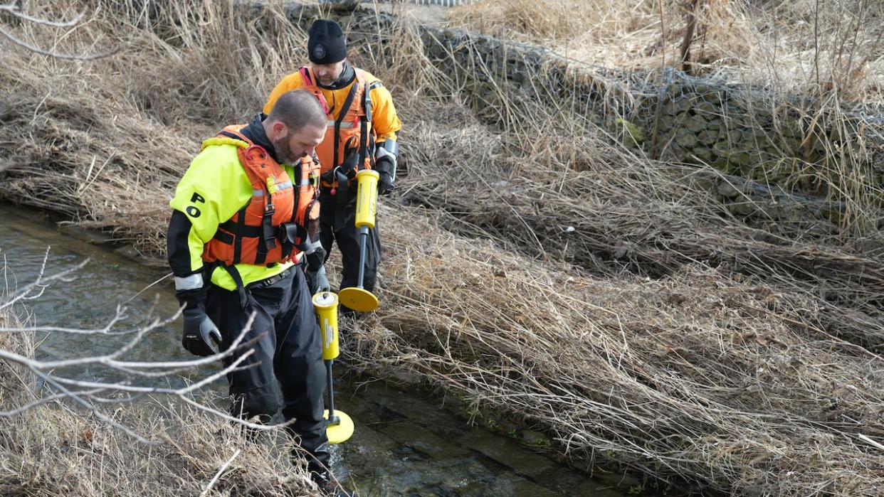 Toronto police say they are searching for evidence at a waterway in Stoney Creek, Ont., Friday morning in connection with two shootings that happened last week near a bus shelter in Toronto in the area of Jane Street and Driftwood Avenue. (Paul Smith/CBC - image credit)