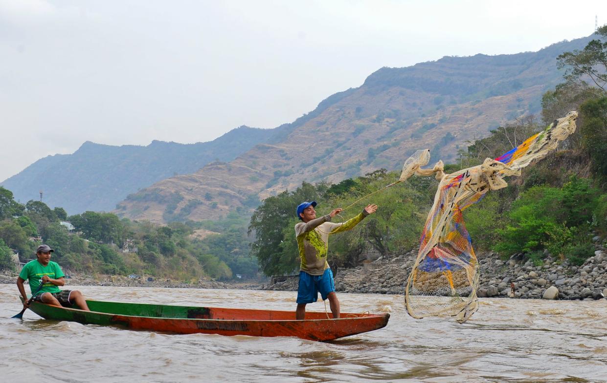 A fisherman throws his net in the Magdalena River in Honda, Tolima department, Colombia.