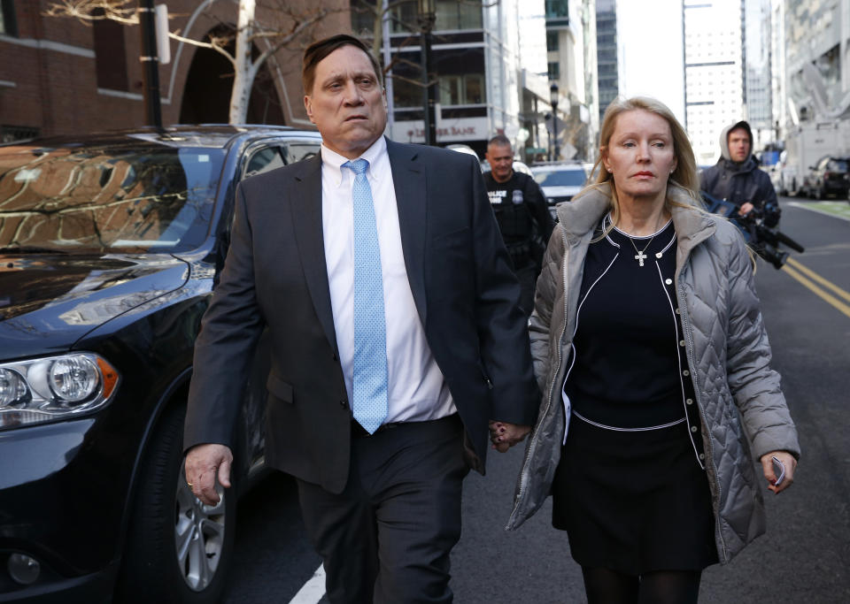 BOSTON, MA - APRIL 3: John Wilson, left, leaves the John Joseph Moakley United States Courthouse in Boston on April 3, 2019. 13 parents were scheduled to appear in federal court in Boston Wednesday for the first time since they were charged last month in a massive college admissions cheating scandal. They were among 50 people - including coaches, powerful financiers, and entrepreneurs - charged in a brazen plot in which wealthy parents allegedly schemed to bribe sports coaches at top colleges to admit their children. Many of the parents allegedly paid to have someone else take the SAT or ACT exams for their children or correct their answers, guaranteeing them high scores. (Photo by Jessica Rinaldi/The Boston Globe via Getty Images)