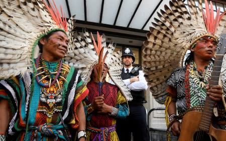 A police officer stands guard as indigenous leaders of the Huni Kuin Kaxinawa from Brazil join a protest organised by Extinction Rebellion against the Brazilian government's environmental polices, outside of the Brazilian Embassy in London, Britain