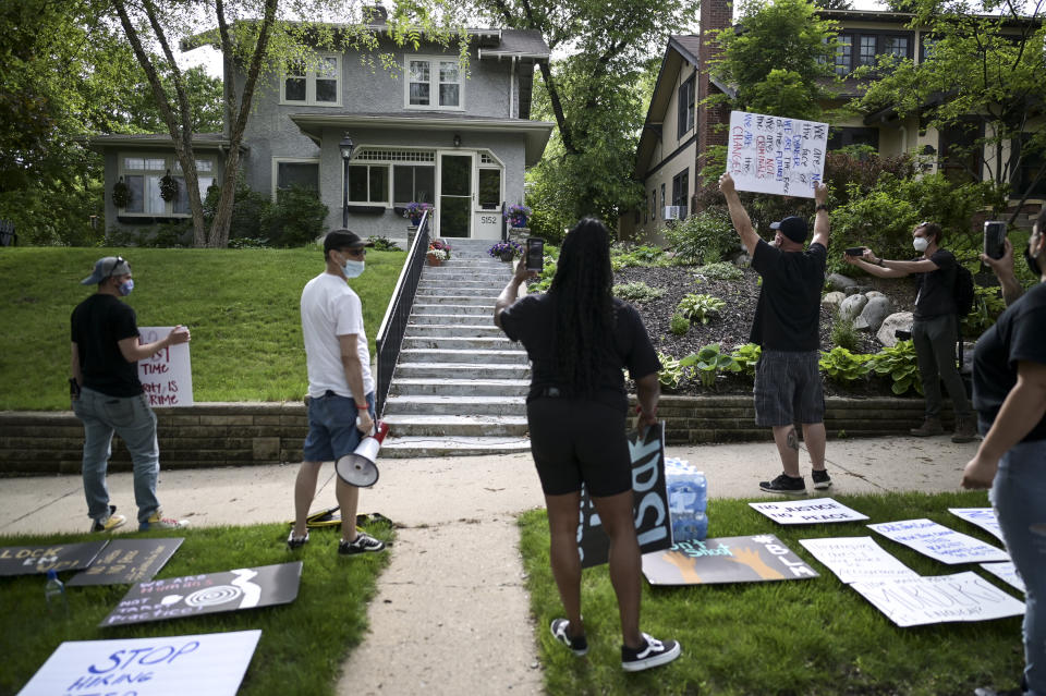 Protesters angered by the death of George Floyd stand Wednesday outside the home of Hennepin County Attorney Mike Freeman in Minneapolis. The mayor of Minneapolis called for criminal charges against the white police officer seen on video kneeling against the neck of a handcuffed Black man who died in police custody. (Photo: Aaron Lavinsky/Star Tribune via AP)