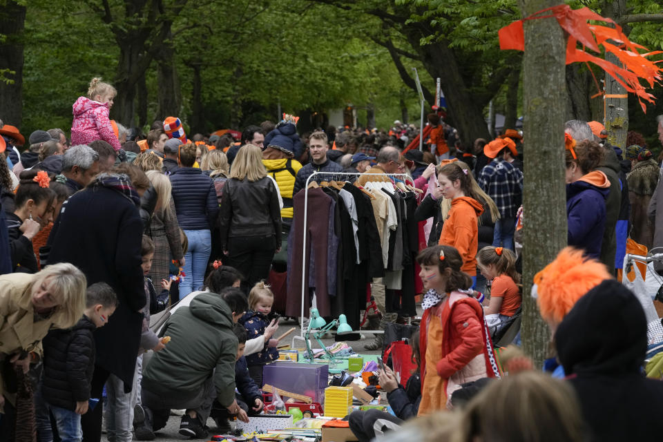 Orange-clad people celebrate King's Day in Amsterdam's Vondelpark, Netherlands, Wednesday, April 27, 2022. After two years of celebrations muted by coronavirus lockdowns, the Netherlands marked the 55th anniversary of King Willem-Alexander of the House of Orange with street parties, music festivals and a national poll showing trust in the monarch ebbing away. (AP Photo/Peter Dejong)