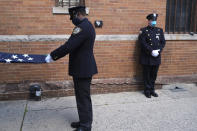 Members of the NYPD Honor Guard, wearing masks, prepare for the funeral of Traffic Section Commander Mohammed Chowdhury in New York, April 22, 2020. Chowdhury died on Sunday, April 19, 2020, from complications related to the new coronavirus. (AP Photo/Seth Wenig)